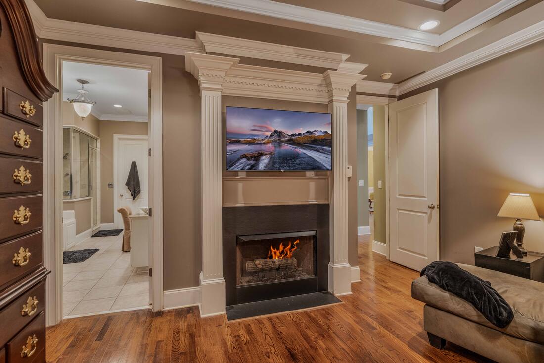 Primary bedroom fireplace in classical millwork