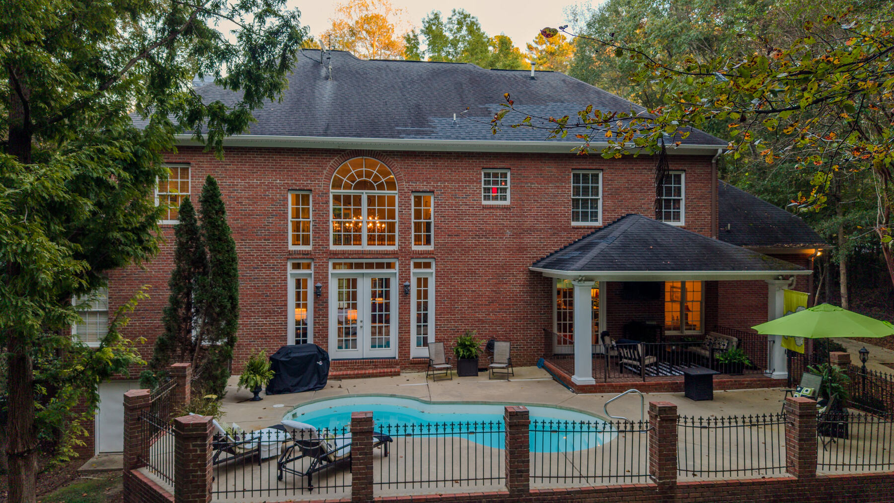 Rear elevation and pool at twilight